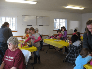 Creative children and parents making Fairy Houses...and one Friend visualizing a NEW LIBRARY with rooms for many projects for all.